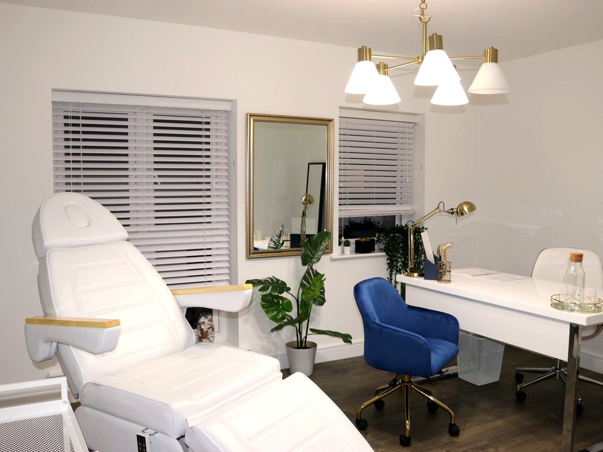 The treatment room at PortoClinic Aesthetics in Kings Hill, lit for an evening appointment